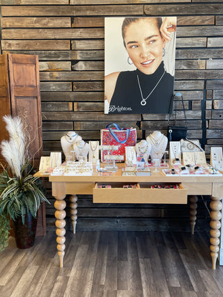 Wooden interior with a portrait of a woman over a table of jewelry